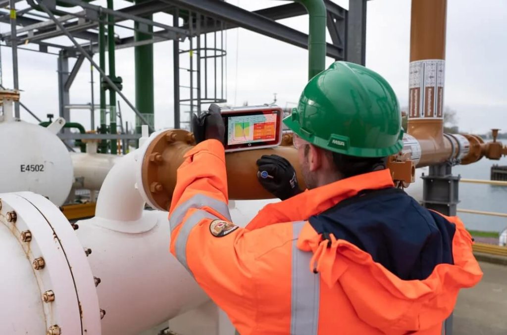 現(xiàn)場工程師使用Krautkr?mer USM100便攜式超聲探傷儀對管道進行無損檢測，監(jiān)測焊縫厚度與腐蝕情況，保障工業(yè)安全。